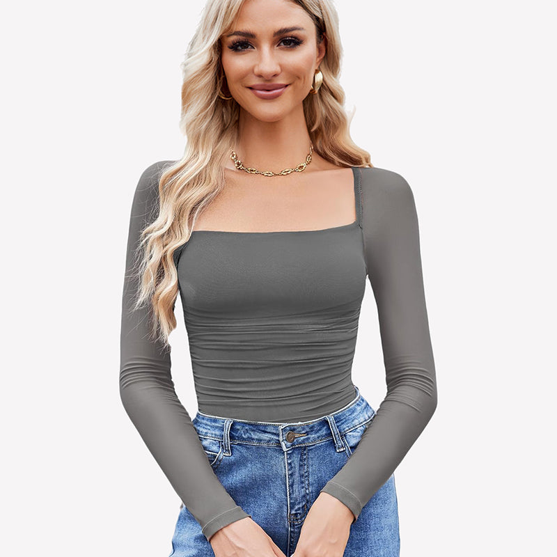 Grey square neck mesh bodysuit with long sleeves, ruched detail. Model in jeans and gold jewelry.