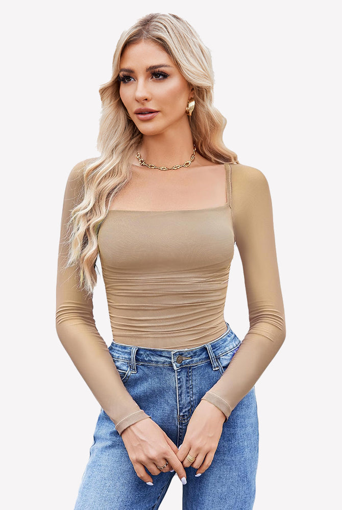 Beige square neck mesh bodysuit with long sleeves, ruched detail, jeans and gold jewelry. Shapewear.