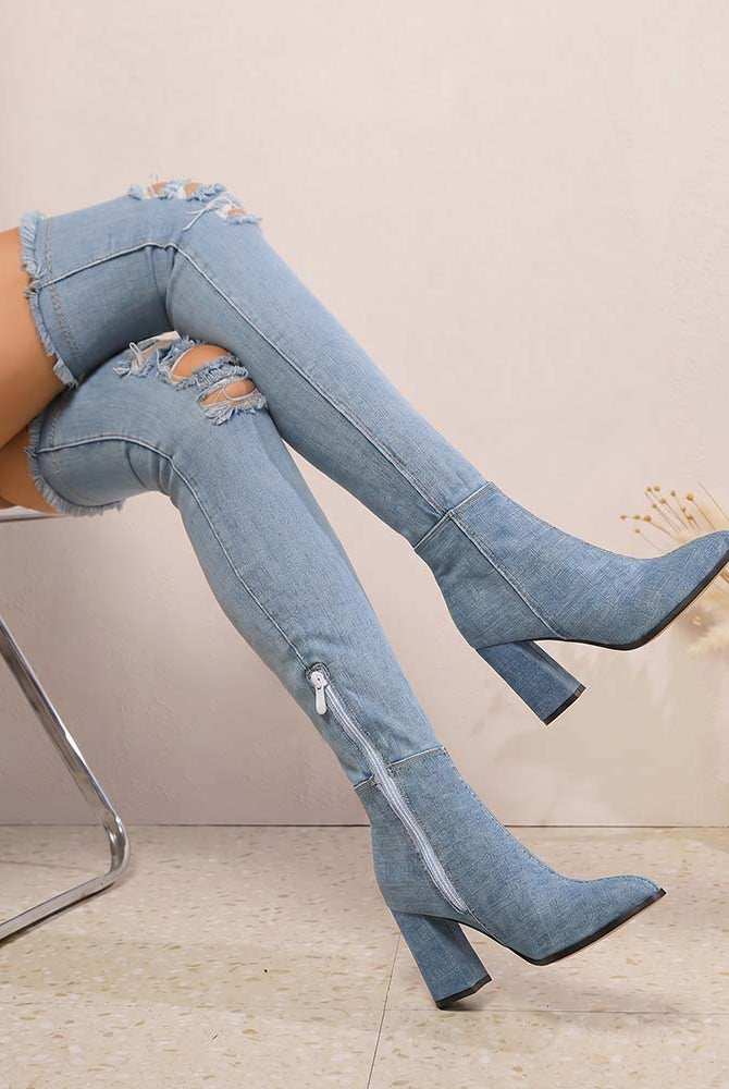 Over-the-knee stiletto boots in light blue denim with distressed cuffs, pointed toe, high heel.