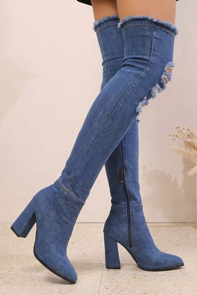 Over-the-knee stiletto boots in blue denim, distressed shaft, pointed toe, stacked high heel.