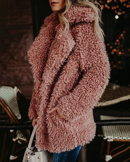 Oversized dusty rose faux fur coat. Soft, textured material, perfect for casual wear.