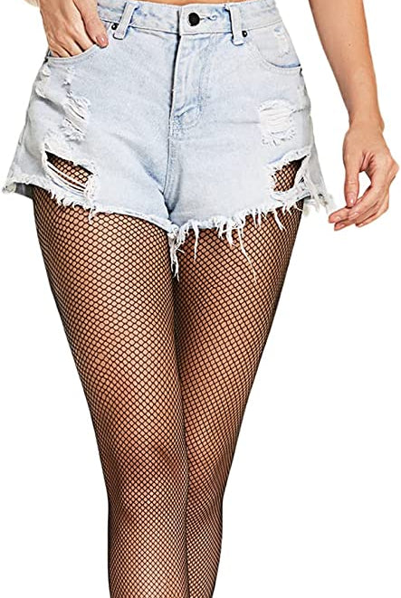 Woman in black fishnet stockings and shorts. Confident and sexy look. Avidlove plus size lingerie.