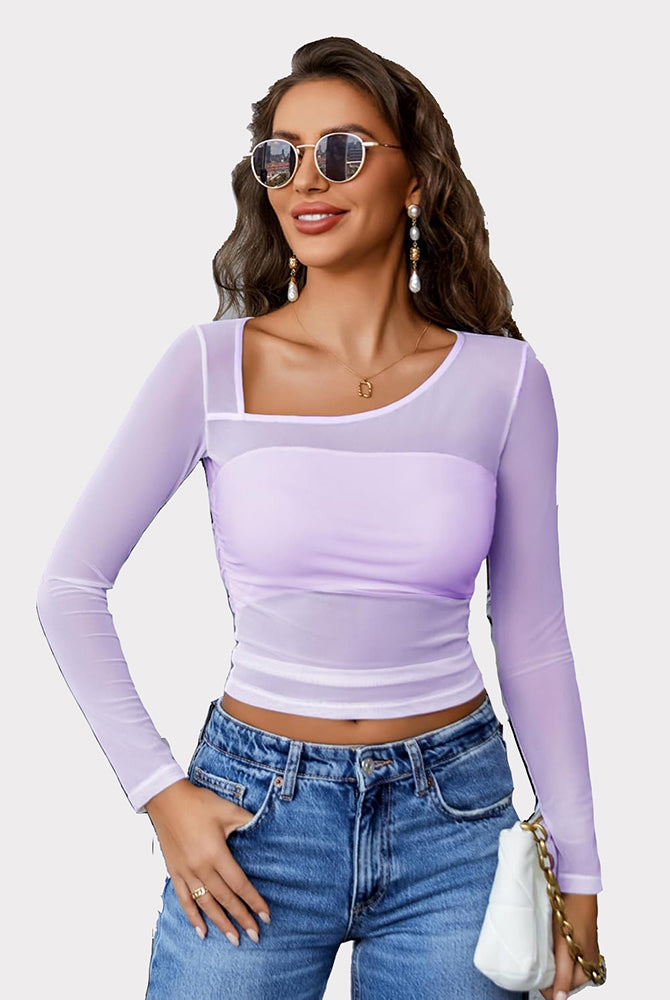 Avidlove lavender mesh asymmetrical crop top with long sleeves and denim jeans. Sheer, stylish top.