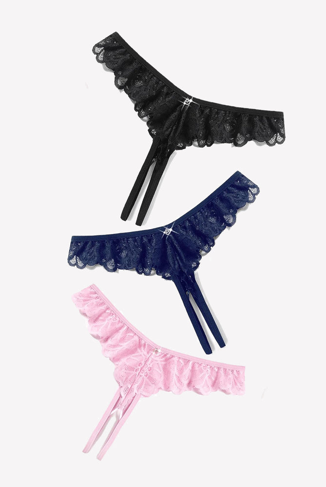 Lace thong briefs in black, navy blue, and pink with criss-cross design and rhinestone details