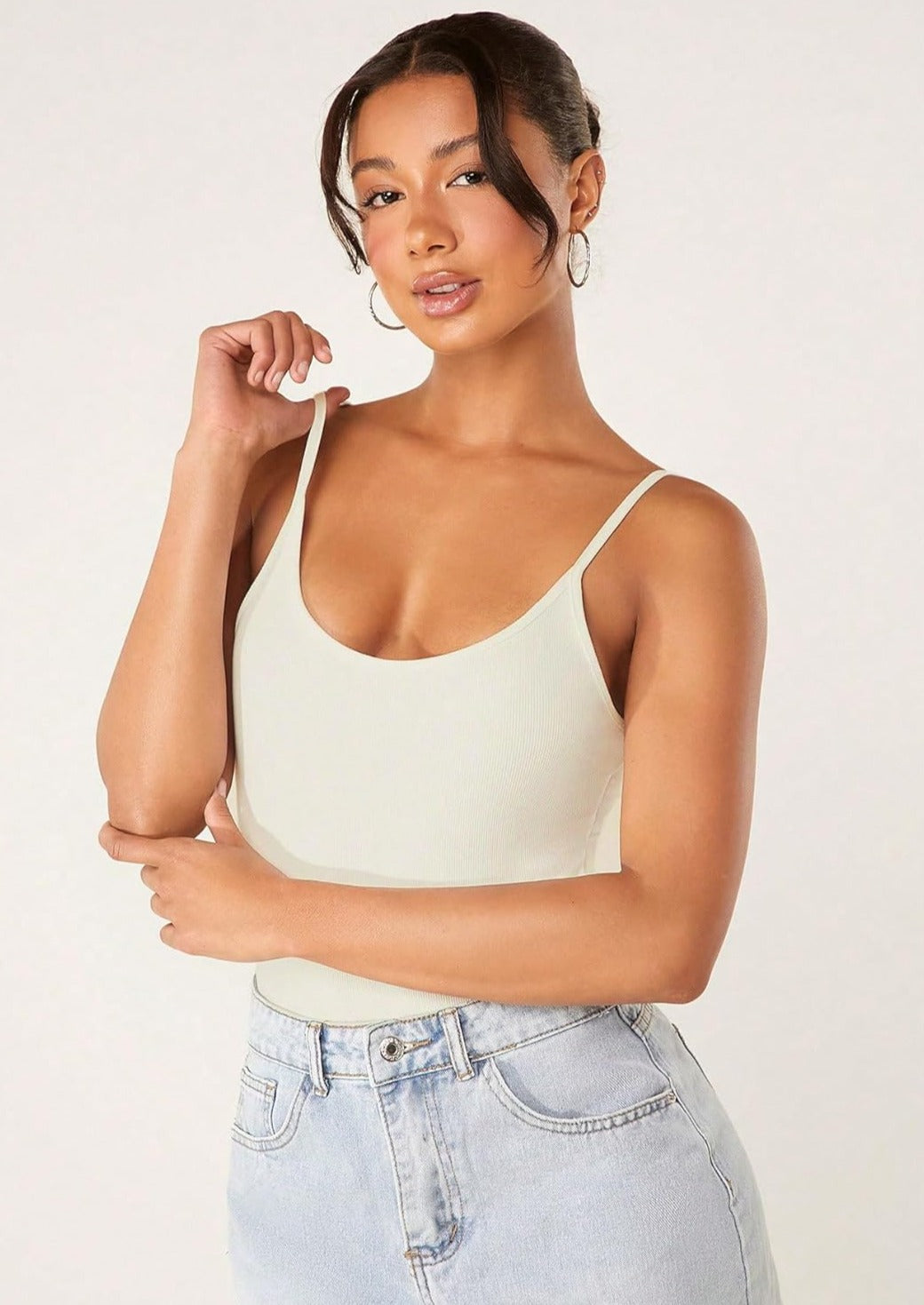 Light green ribbed shapewear tank top, tummy control, spaghetti straps, model in high-waisted jeans