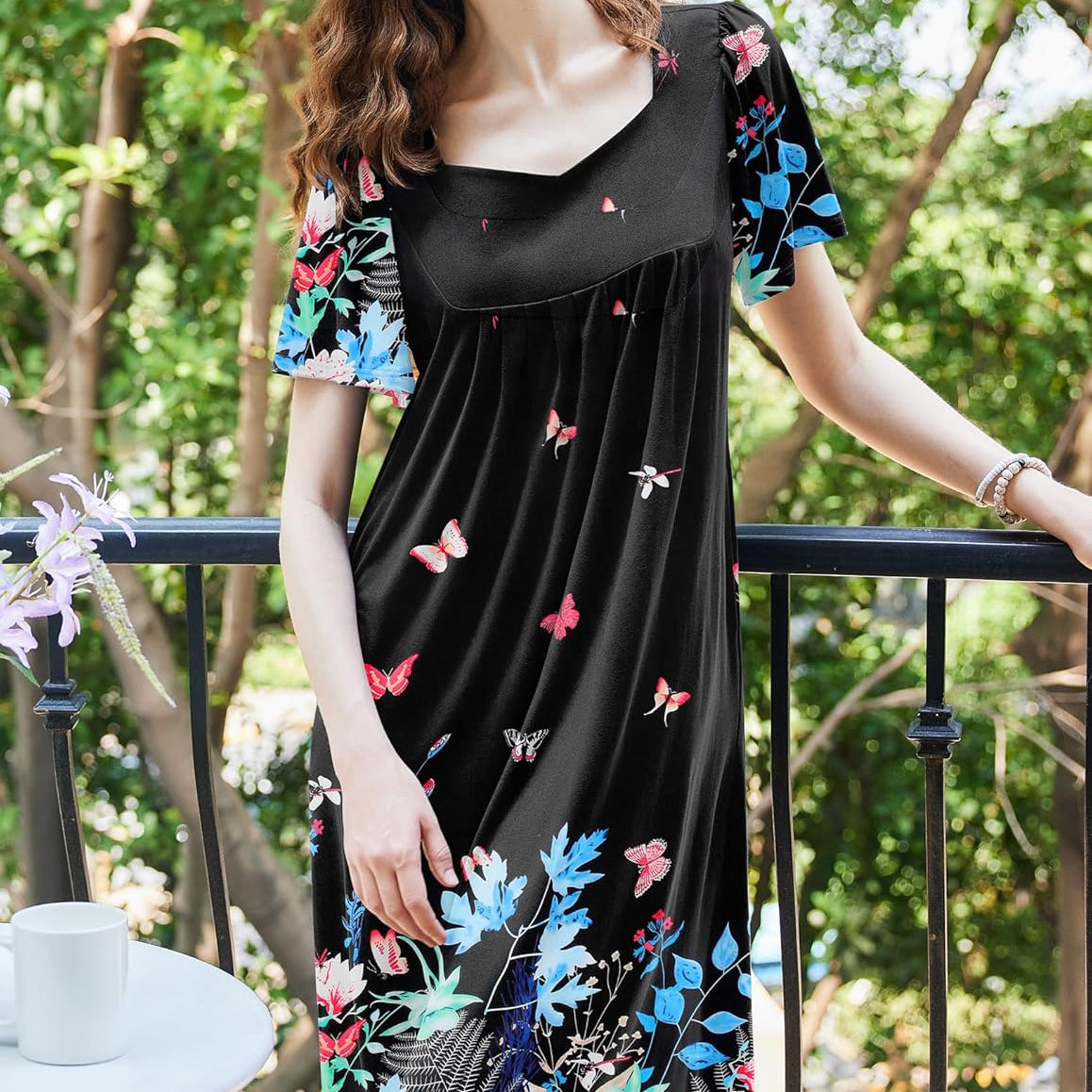 Black house dress with colorful butterfly print, empire waist and short flared sleeves