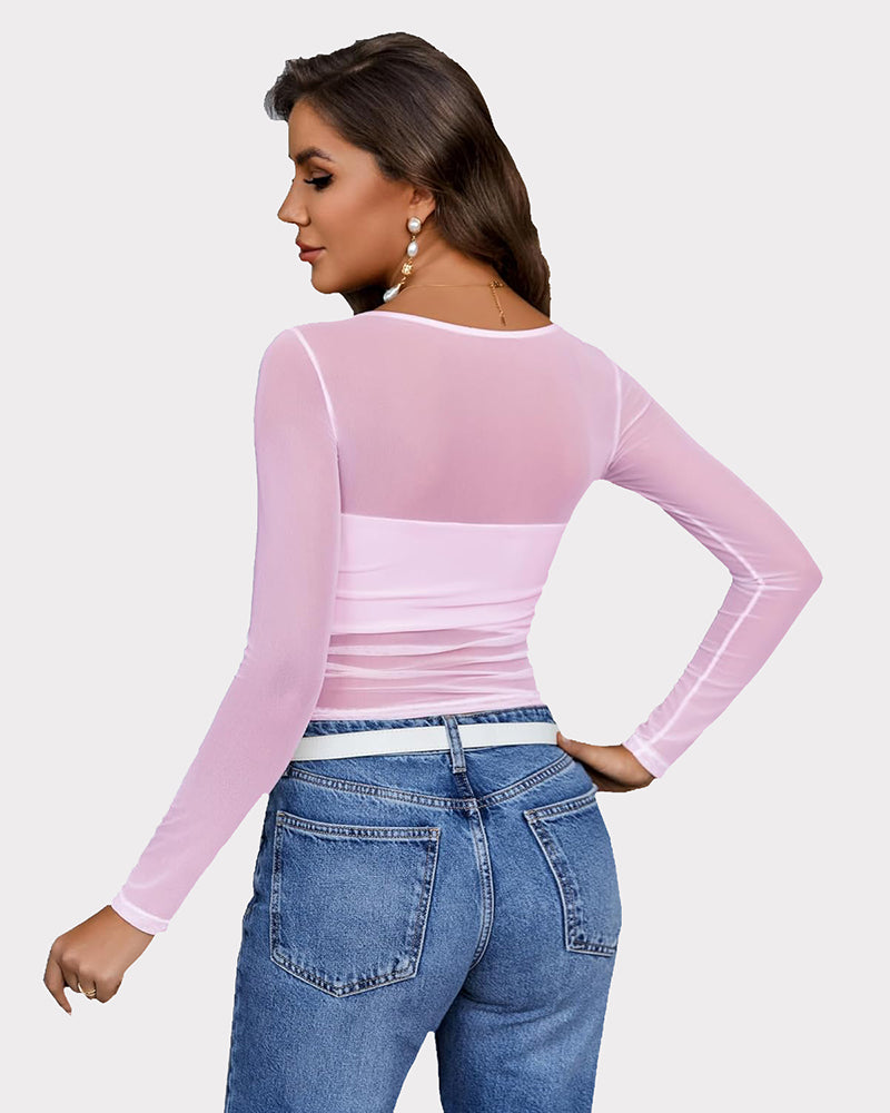 Pink mesh asymmetrical crop top with long sleeves and denim jeans. See-through top from Avidlove.