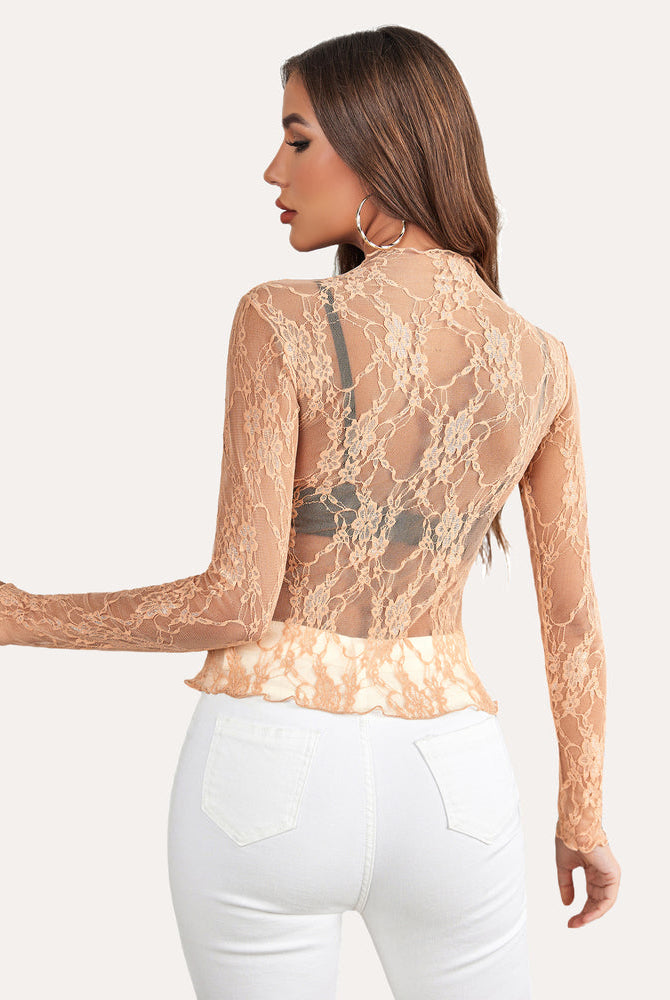 Peach floral lace mock neck sheer blouse with long sleeves on a woman, stylish and sexy mesh top