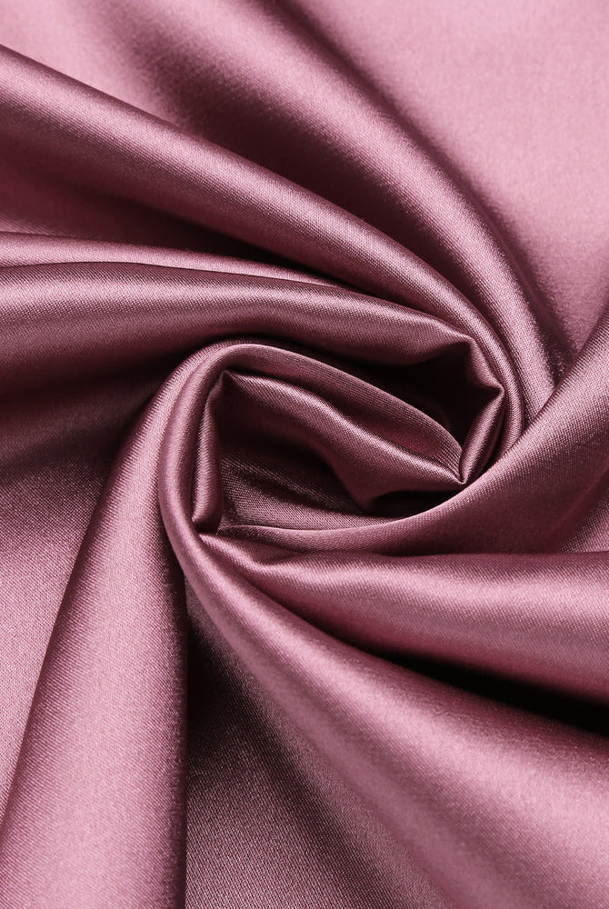Dusty rose satin fabric detail for sleepwear, showcasing smooth texture and sheen.