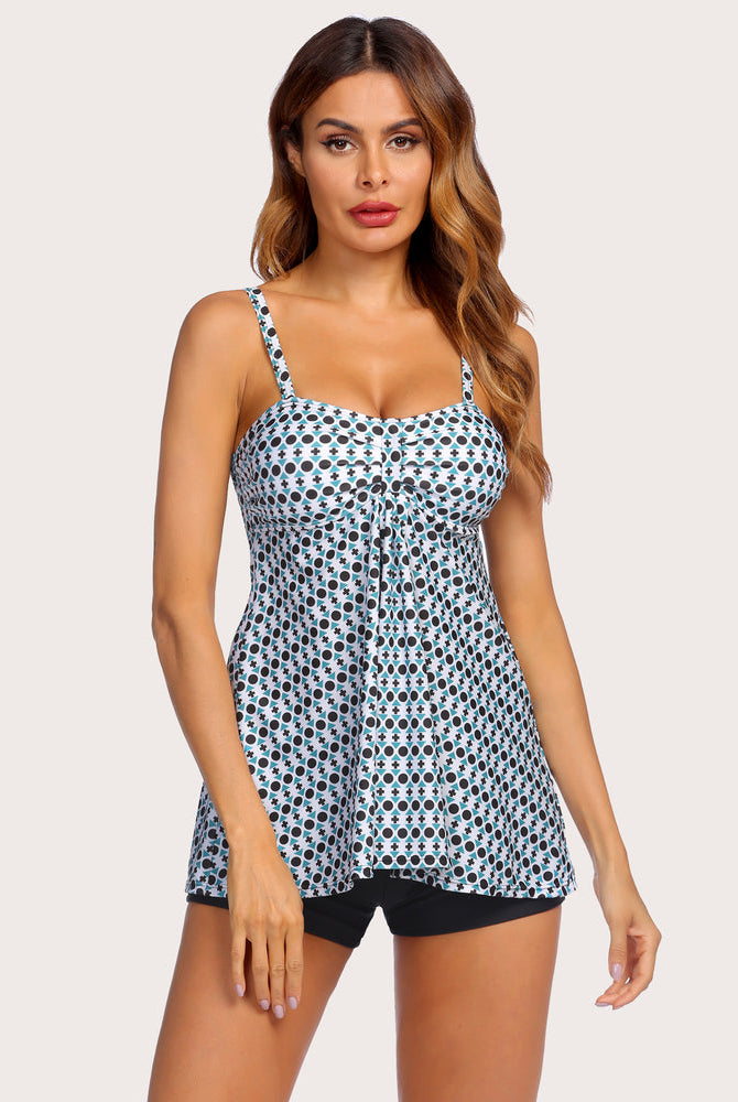 Polka dot tankini swimsuit for women with adjustable straps and black shorts. Stylish swimwear.