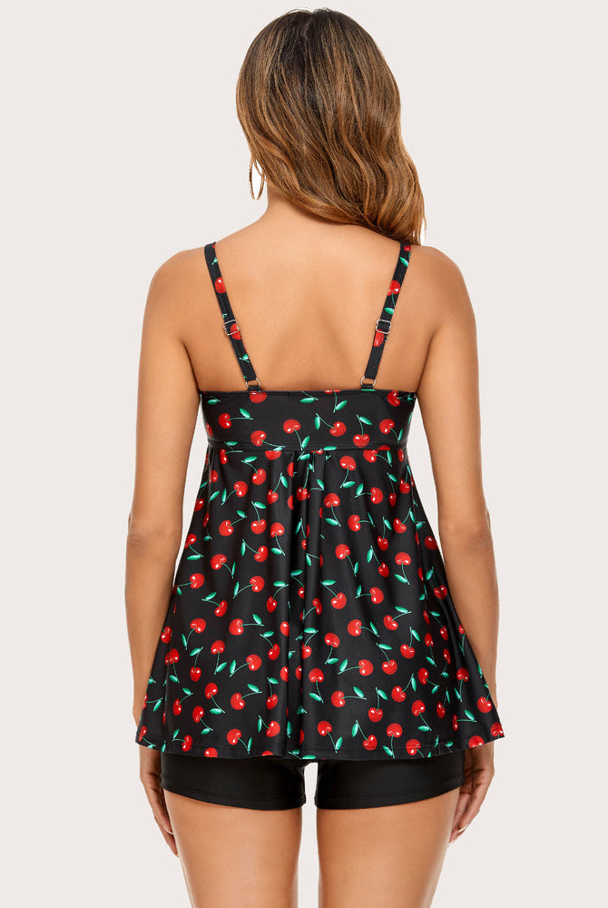 Retro cherry print tankini with black swim shorts. Adjustable straps, sun-protective swimwear.