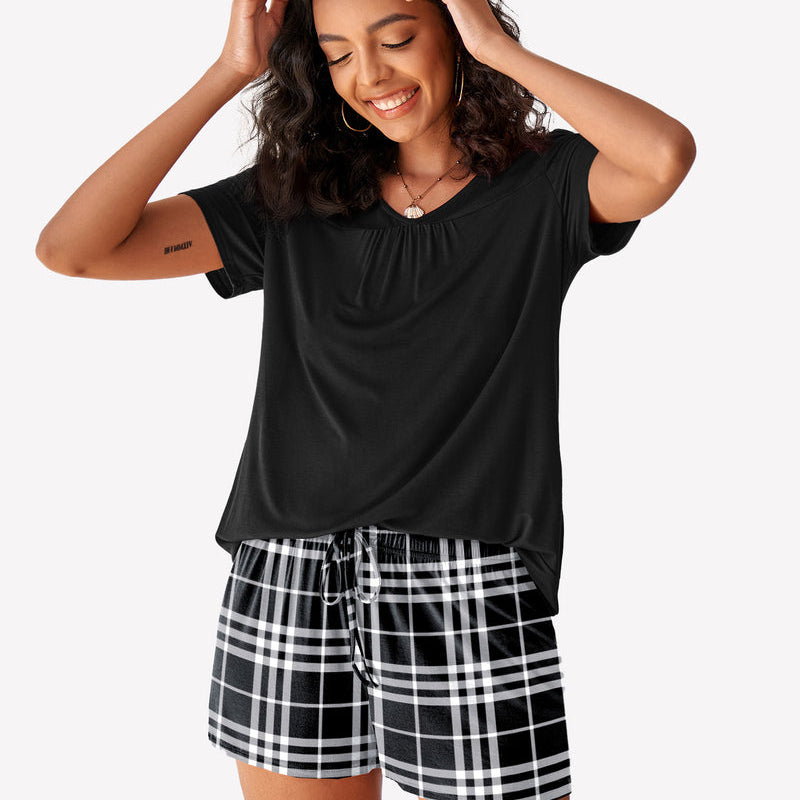 Women's black short sleeve pajama set with checkered shorts. Soft and breathable loungewear