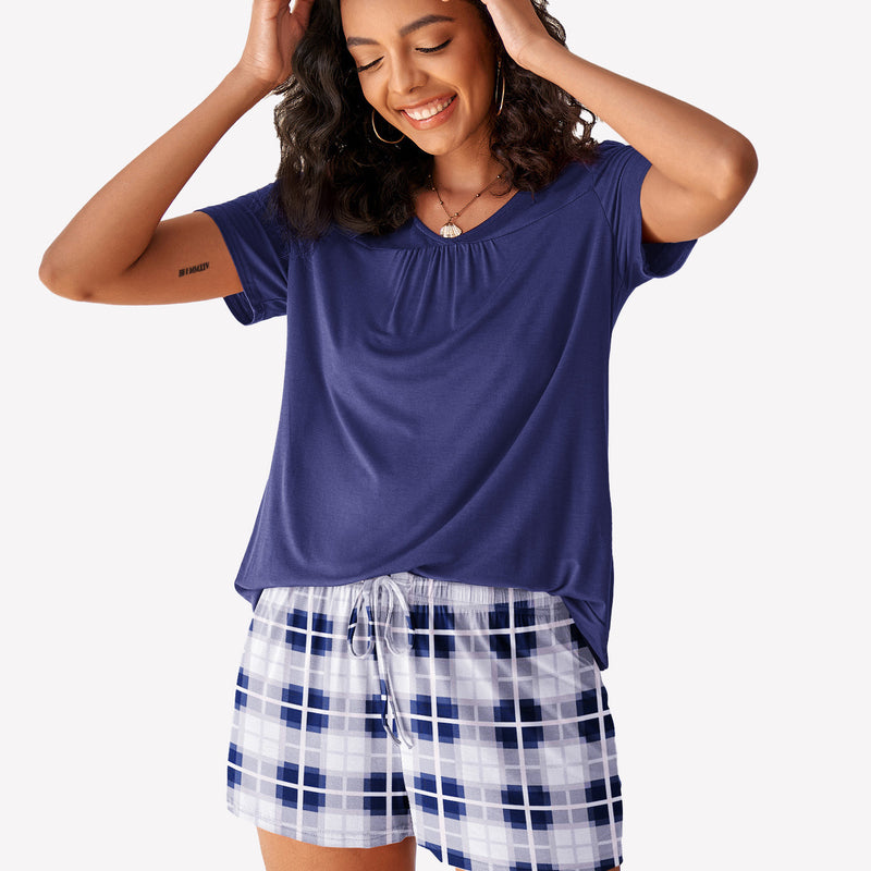 Women's navy short sleeve pajama set. Blue top with checkered shorts. Comfortable loungewear.