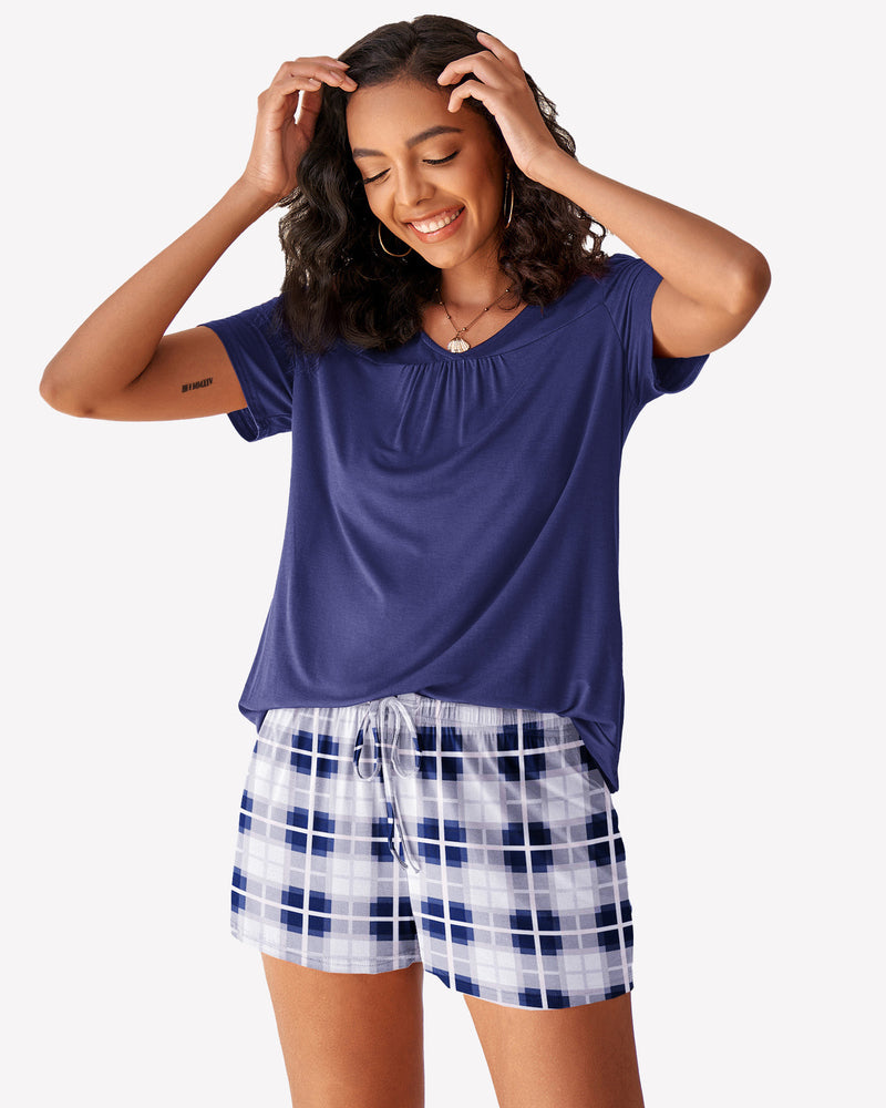 Women's navy short sleeve pajama set. Blue top with checkered shorts. Comfortable loungewear.