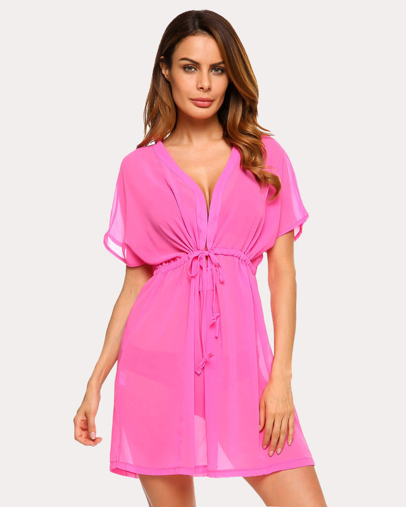 Pink chiffon swimsuit cover-up with deep V-neck and drawstring waist. Summer beach essential.