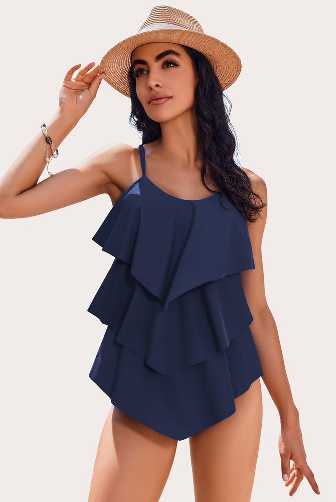 Navy blue ruffle tankini swimsuit with adjustable straps and layered design, perfect beachwear.