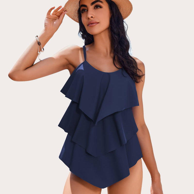 Navy blue ruffle tankini swimsuit with adjustable straps and layered design, perfect beachwear.