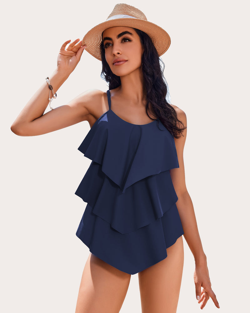 Navy blue ruffle tankini swimsuit with adjustable straps and layered design, perfect beachwear.