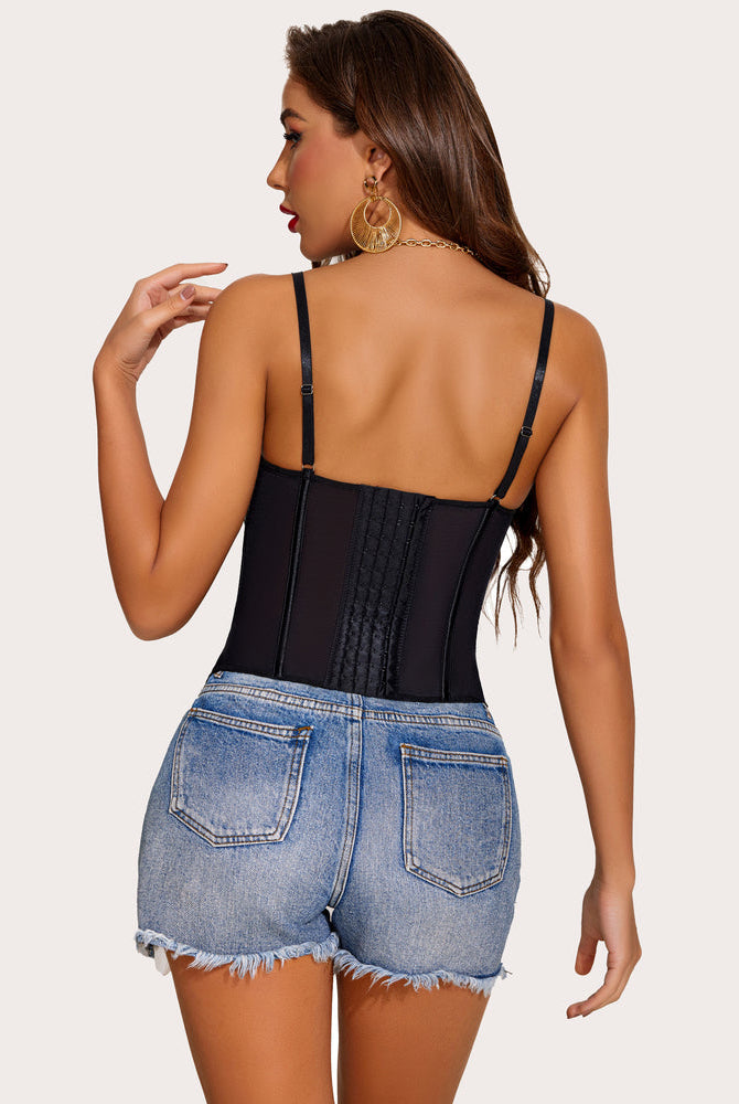 Black lace bustier corset top with adjustable straps and denim shorts. Perfect for a night out.