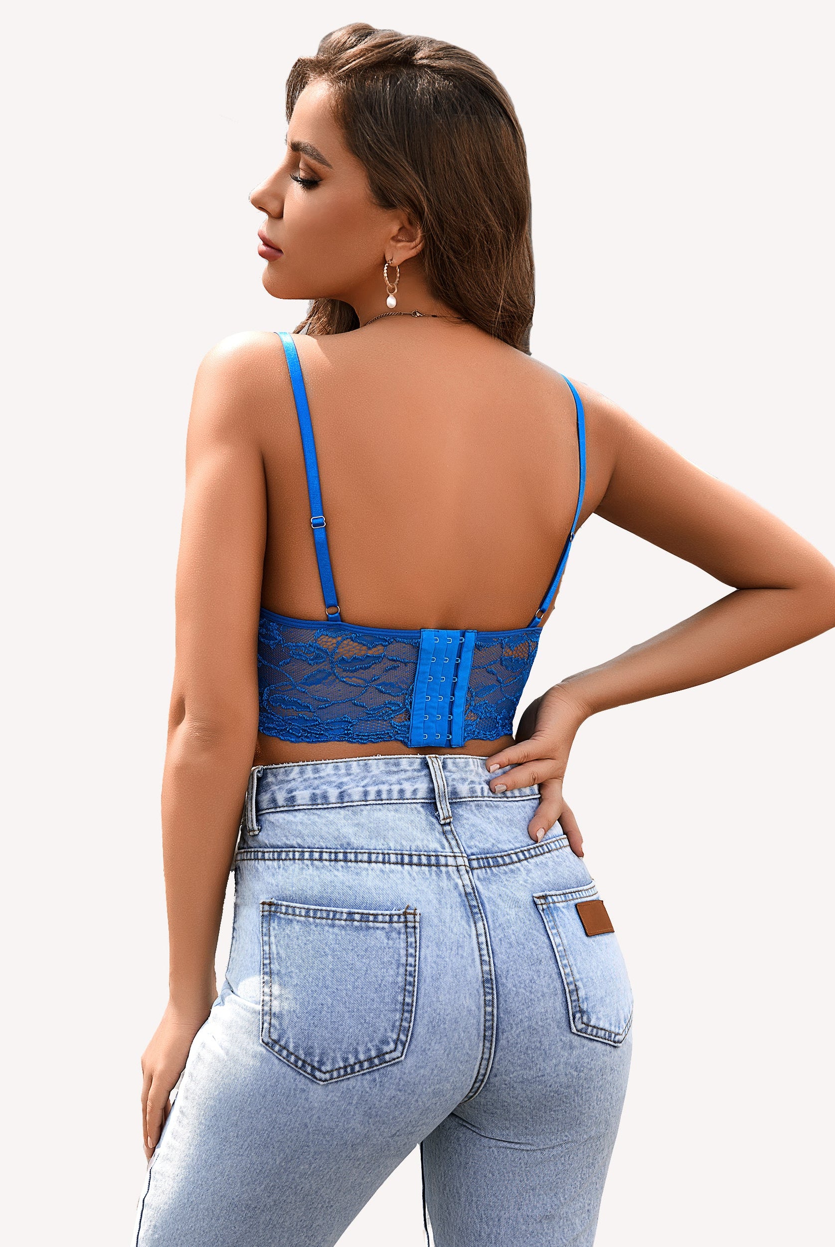 Blue lace bralette crop top with adjustable straps and denim jeans