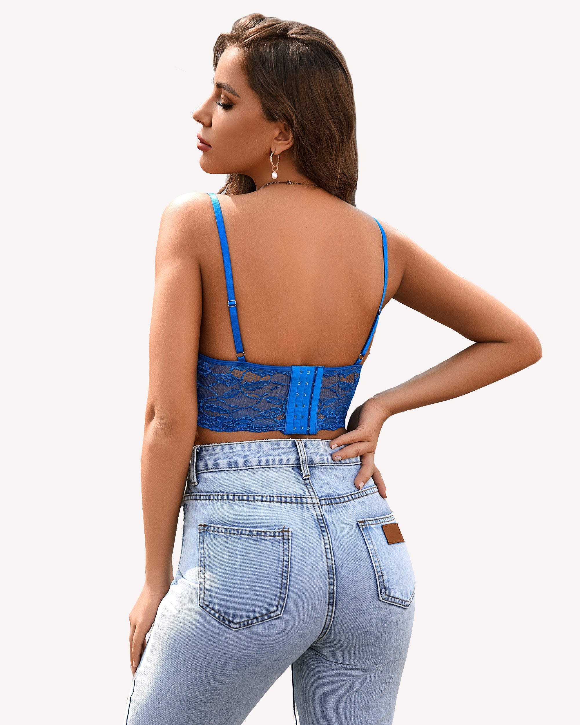 Blue lace bralette crop top with adjustable straps and denim jeans