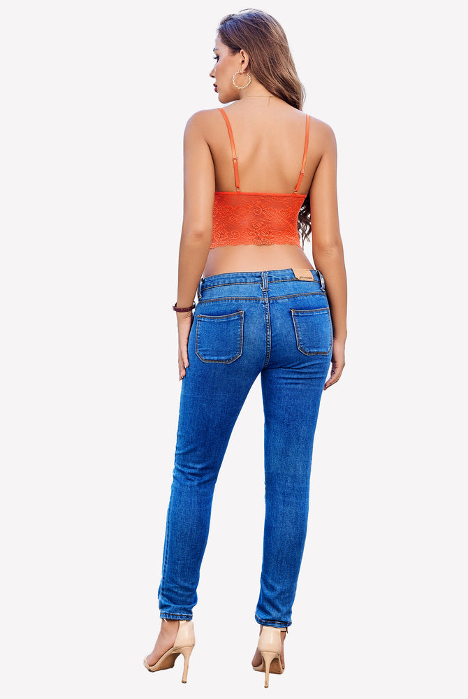 Orange lace bralette top with spaghetti straps, paired with jeans. Sexy lingerie look.