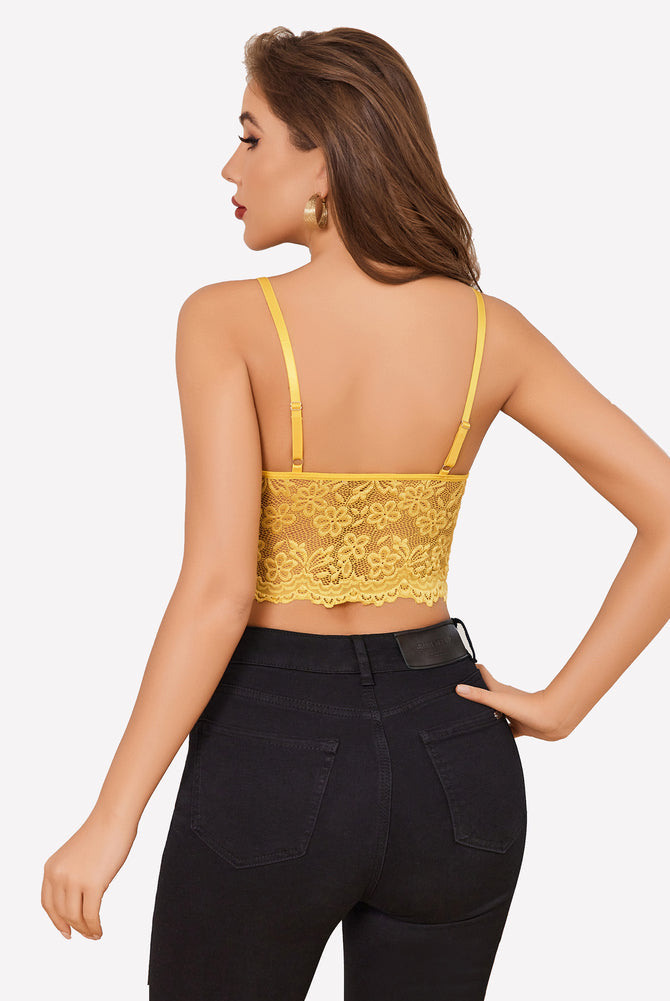 Yellow lace bralette crop top and black jeans. Sexy lingerie for women with adjustable straps.
