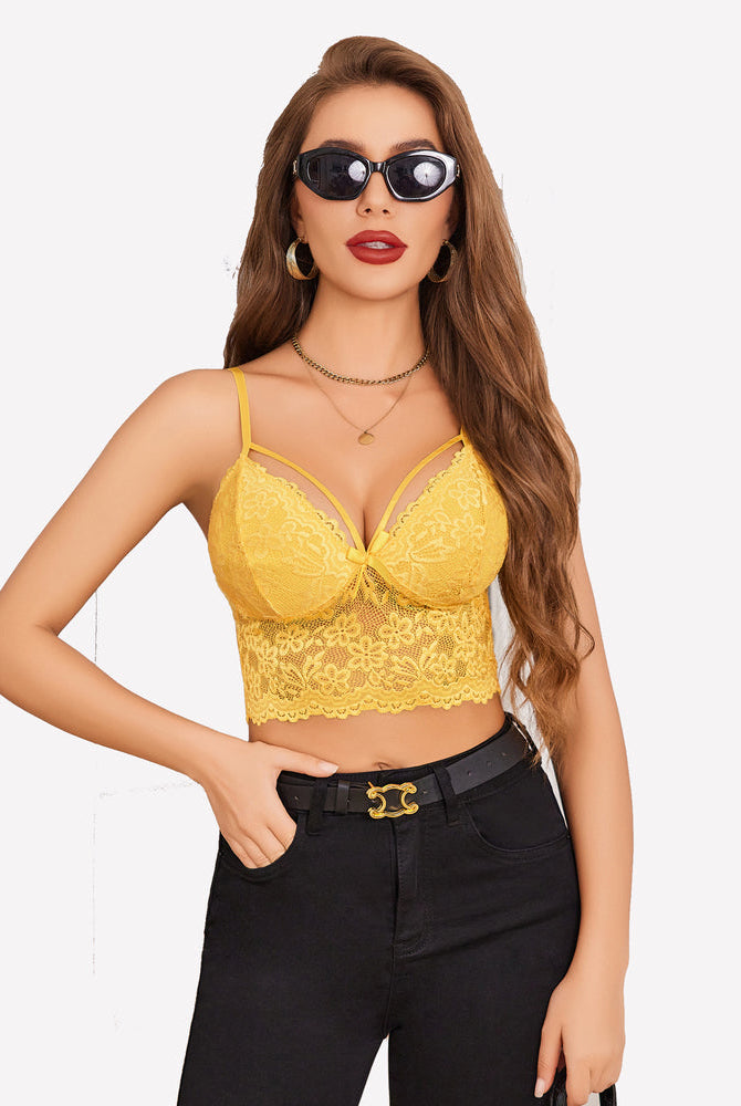 Yellow lace bralette crop top with adjustable straps. Sexy lingerie and black jeans outfit.