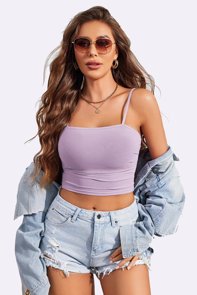 Light purple spaghetti strap tank top with denim shorts and jacket. Stylish and flattering fit.