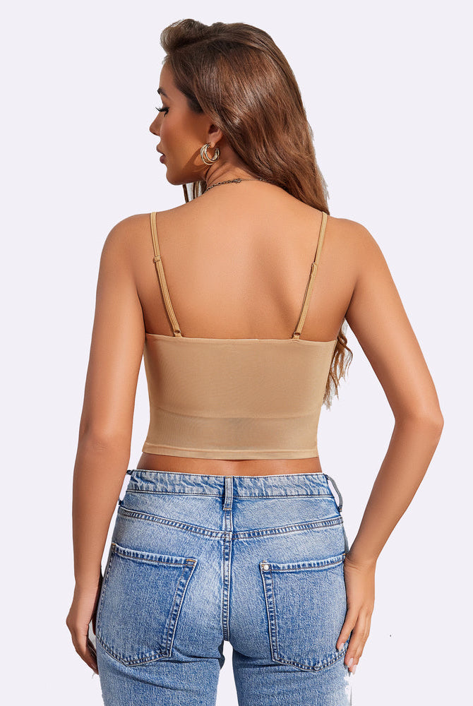 Beige mesh spaghetti strap tank top, layered design, paired with blue jeans. A flattering fit.