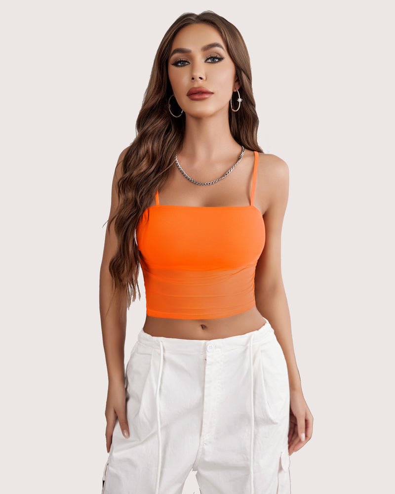 Orange mesh spaghetti strap tank top, layered design, paired with white pants, flattering fit.