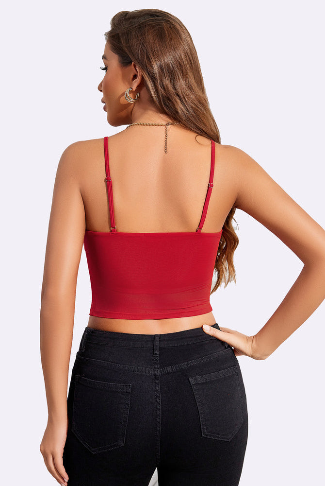 Red mesh spaghetti strap tank top paired with black jeans. Stylish and flattering design.