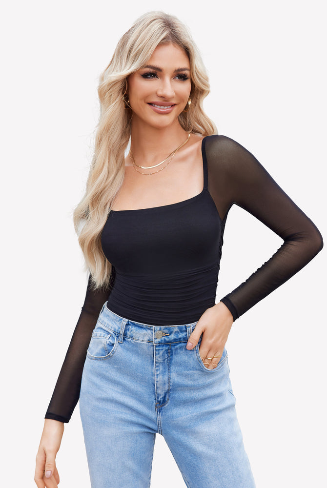 Black square neck mesh bodysuit shapewear, ruched detail, with jeans. Model wearing gold jewelry