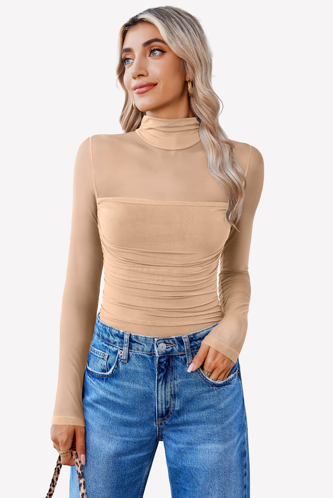 Nude mesh bodysuit with turtleneck and ruched front, paired with blue jeans. Going out outfit.