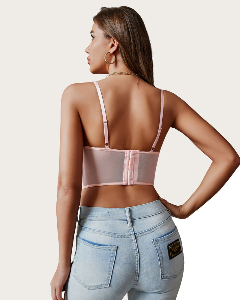 Pink lace racerback crop top with adjustable straps on a model, paired with jeans and gold jewelry