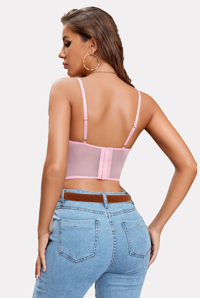 Pink lace underwired crop top with adjustable straps, lingerie look on a woman with blue jeans.