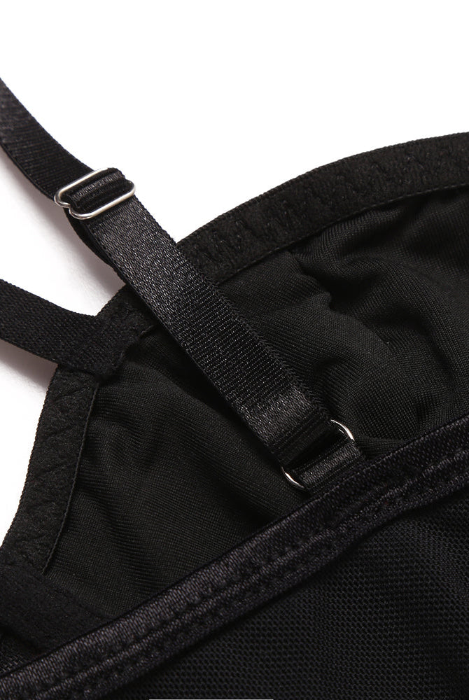 Black corset top detail: adjustable straps, mesh material, and hook closure, perfect for nights out.