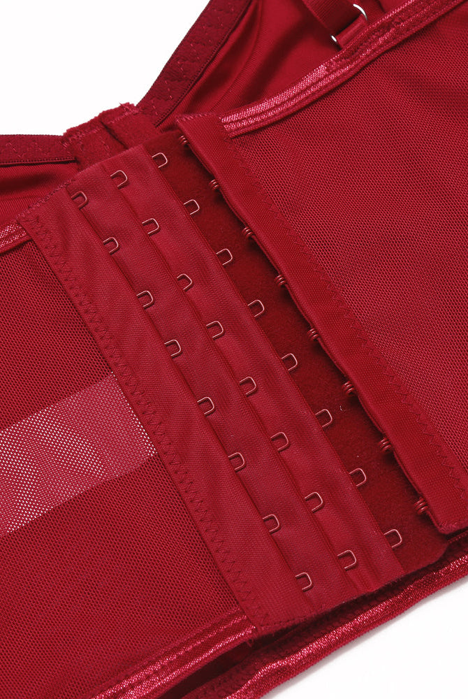 Red corset top with hook closure, adjustable straps, and mesh details. Slim fit bustier.