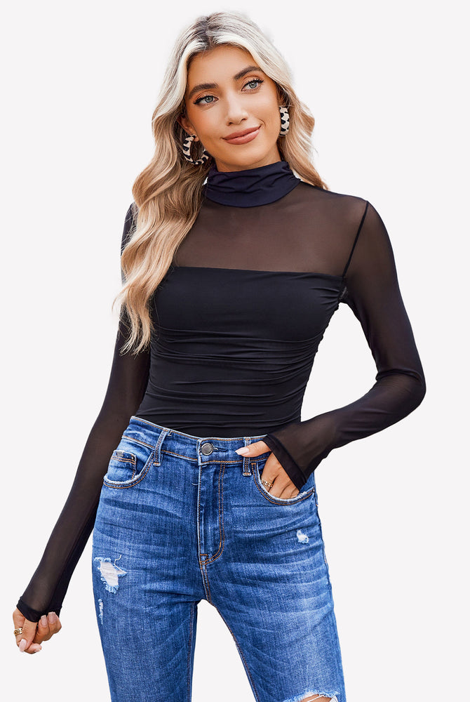 Black turtle neck bodysuit with mesh sleeves and blue denim jeans. Going out outfits for women.