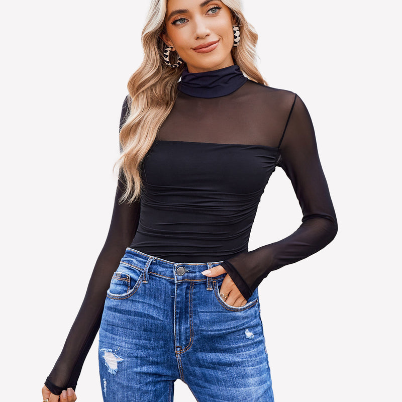 Black turtle neck bodysuit with mesh sleeves and blue denim jeans. Going out outfits for women.