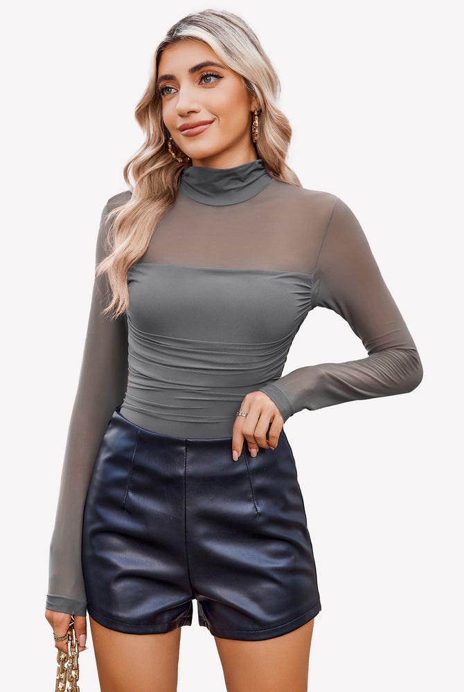 Grey mesh turtleneck bodysuit with ruched front and black shorts, perfect for a night out.