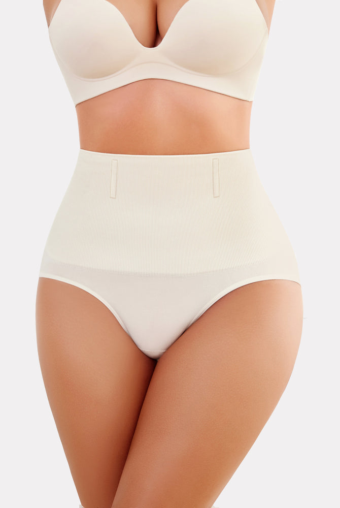 Beige high-waisted tummy control shapewear, enhancing curves and offering a smooth silhouette