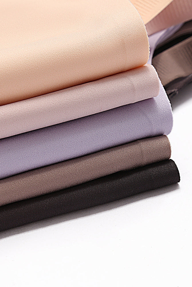 Soft, breathable nursing bra fabric samples in beige, lavender, brown and black. Discreet support.