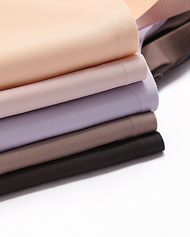 Soft, breathable nursing bra fabric samples in beige, lavender, brown and black. Discreet support.