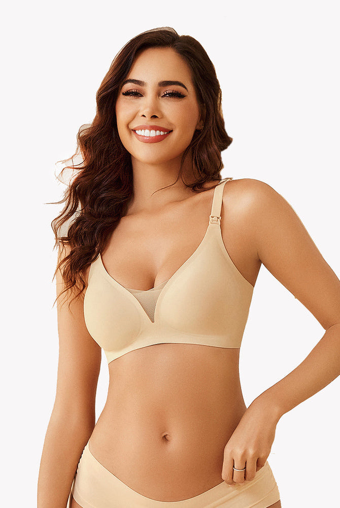 Beige wireless nursing bra, model smiling, comfortable and discreet breastfeeding support.
