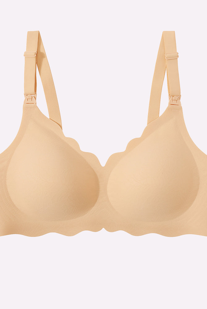 Seamless beige nursing bra with adjustable straps and easy nursing access.