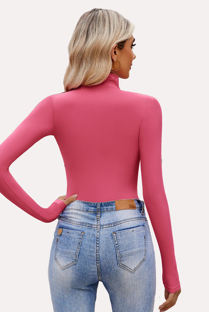 Fuchsia high-neck long sleeve bodysuit shapewear paired with denim jeans, a stylish look.