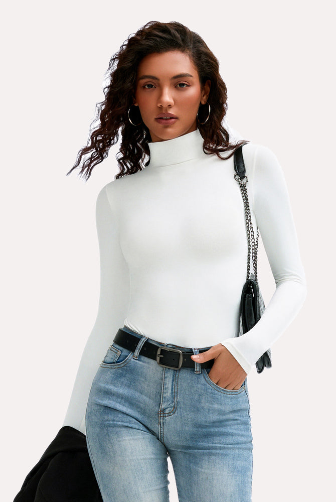 White high-neck long sleeve bodysuit with jeans and black belt, a stylish and flattering look.