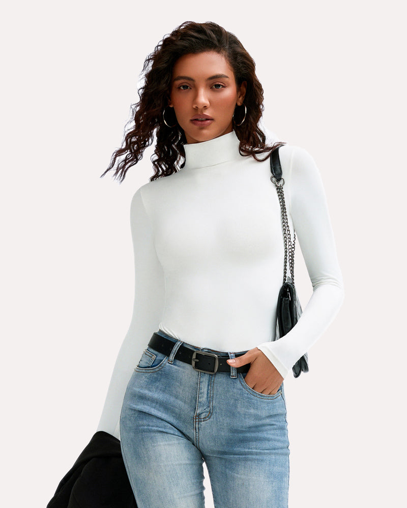 White high-neck long sleeve bodysuit with jeans and black belt, a stylish and flattering look.