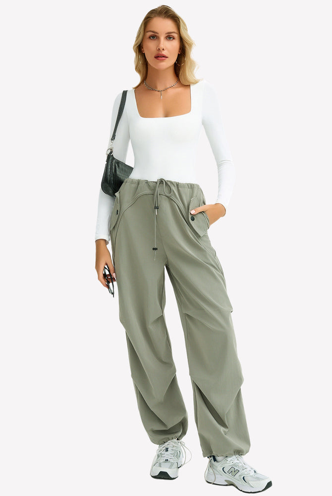White square neck bodysuit paired with green cargo pants. Comfortable and form-fitting design.